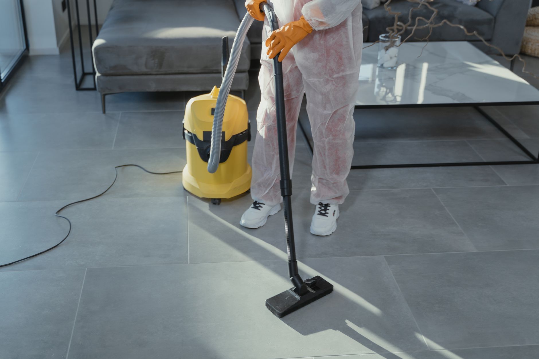 A Tech Pro Mold Removal technician explaining the remediation process and findings to a homeowner in a clean, well-lit Prosper kitchen.
